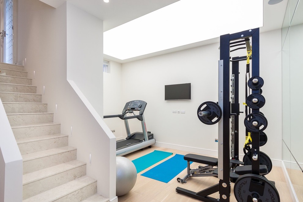 Design ideas for a small contemporary multipurpose gym in London with white walls.