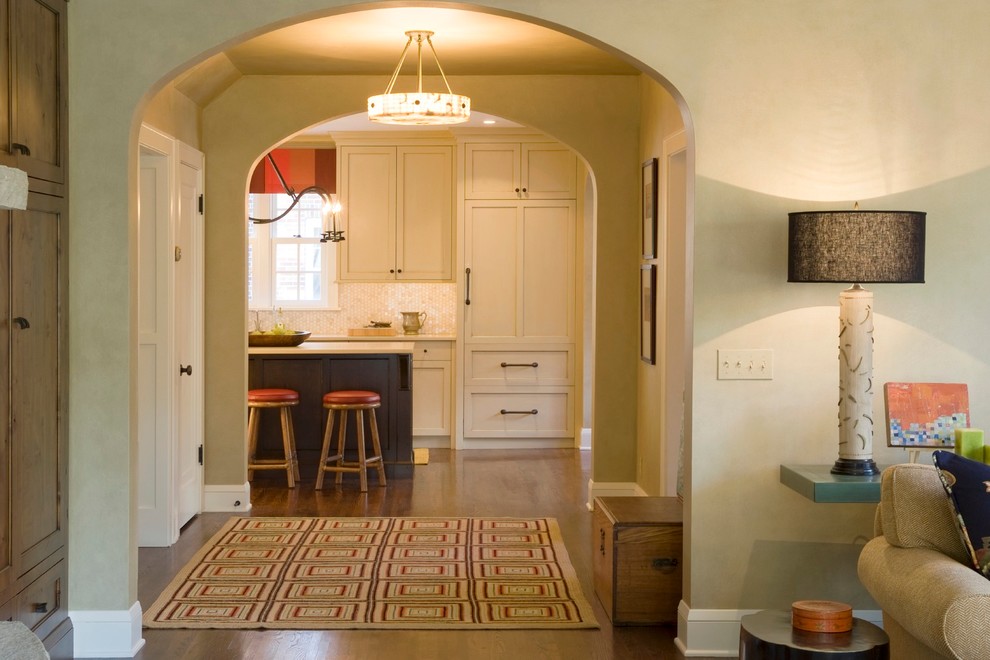 Inspiration for a large transitional l-shaped dark wood floor open concept kitchen remodel in Minneapolis with a single-bowl sink, shaker cabinets, white cabinets, white backsplash, mosaic tile backsplash, paneled appliances and an island
