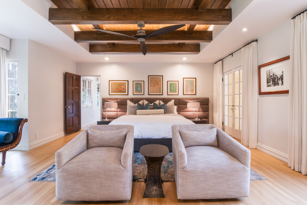 Photo of a large transitional master bedroom in Los Angeles with beige walls, medium hardwood floors and brown floor.