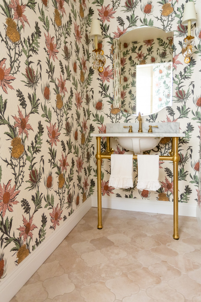 This is an example of a small bathroom in Santa Barbara with open cabinets, a two-piece toilet, multi-coloured walls, porcelain flooring, a pedestal sink, marble worktops, beige floors, white worktops, an enclosed toilet, a single sink, a freestanding vanity unit and wallpapered walls.