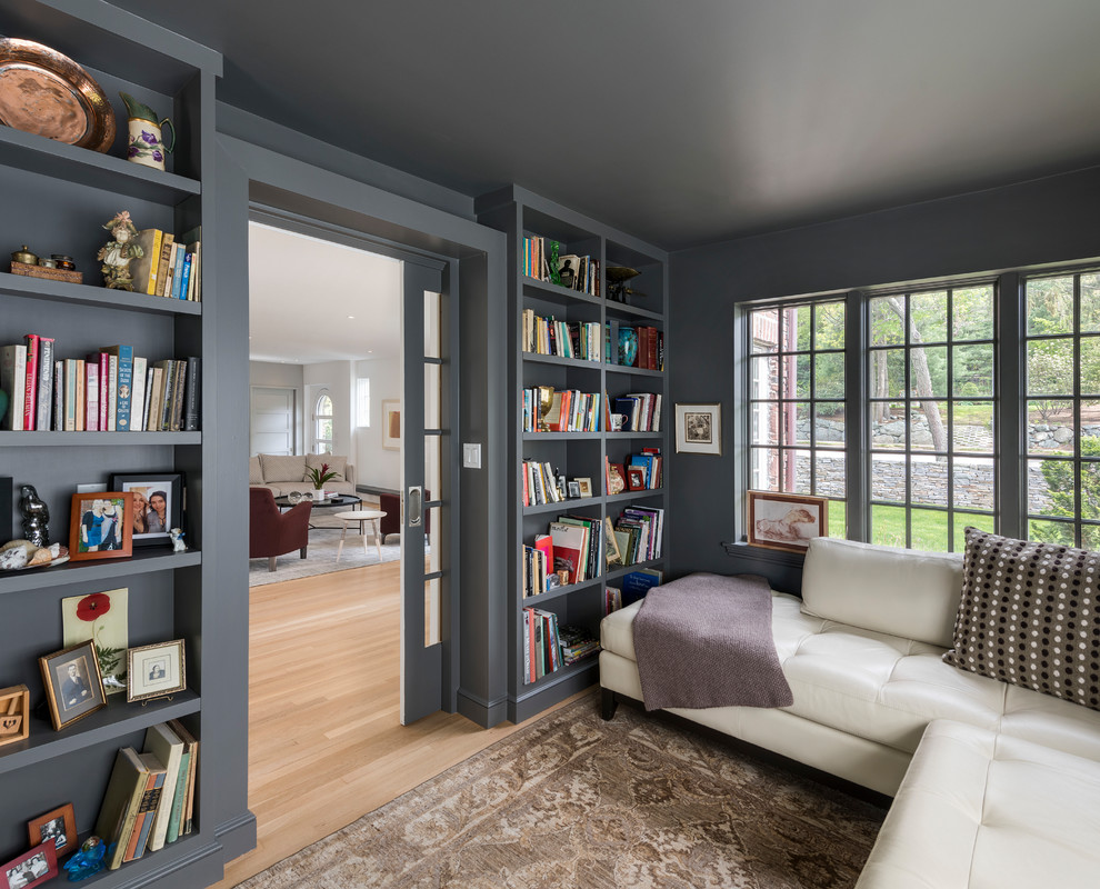 This is an example of a small transitional enclosed family room in Boston with medium hardwood floors, a library, grey walls and brown floor.