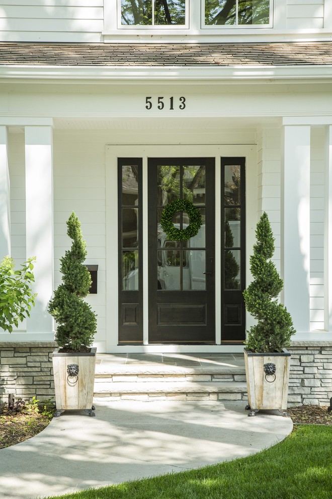Transitional two-story white entryway photo in Minneapolis