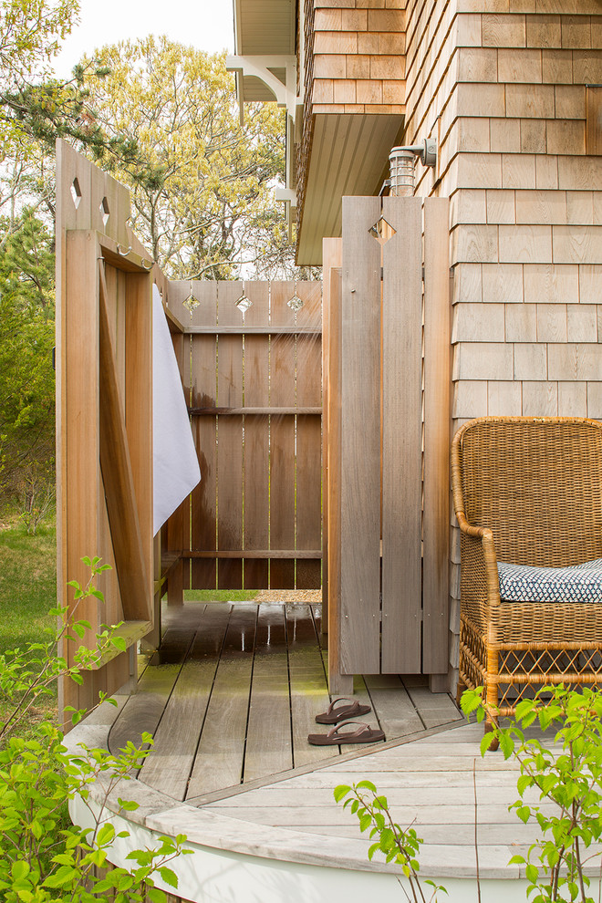 Photo of a beach style side yard deck in Boston with an outdoor shower and no cover.