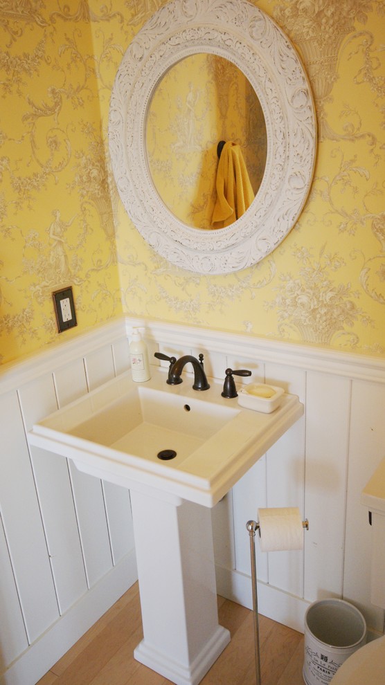 Small country 3/4 bathroom in Calgary with yellow walls and light hardwood floors.