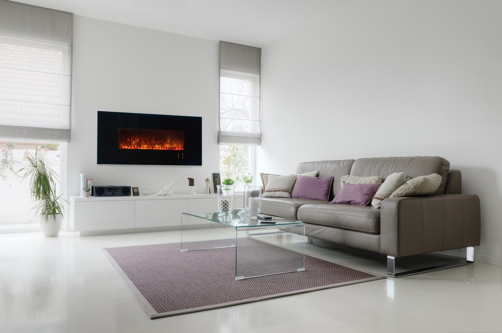 This is an example of a mid-sized contemporary living room in New York with beige walls, a hanging fireplace and beige floor.