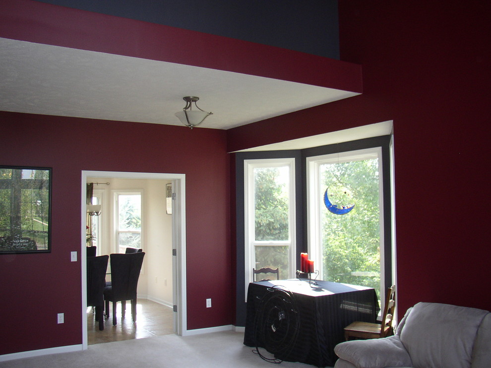 Mid-sized transitional open concept family room in Grand Rapids with red walls, carpet, no fireplace and grey floor.