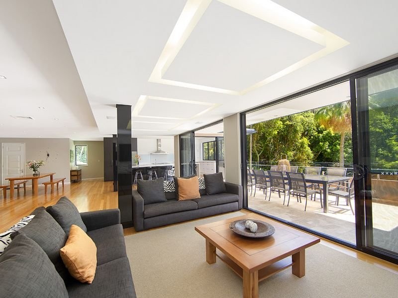 Inspiration for a large contemporary open concept family room in Sydney with light hardwood floors.