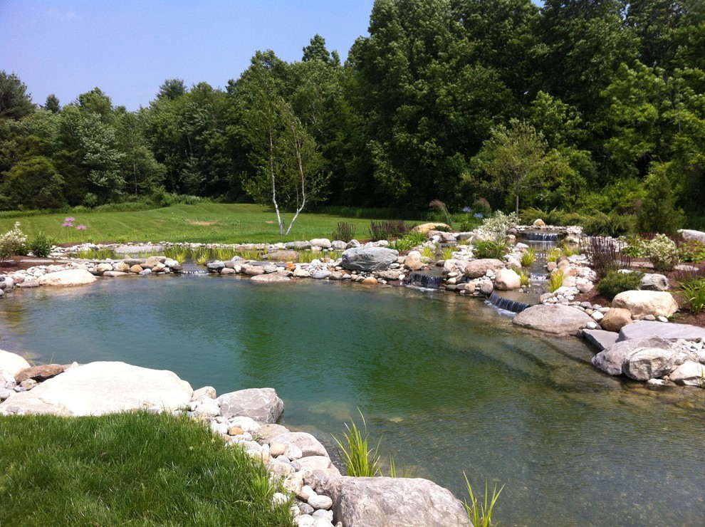 Design ideas for a large country backyard full sun garden in Burlington with with pond and natural stone pavers.