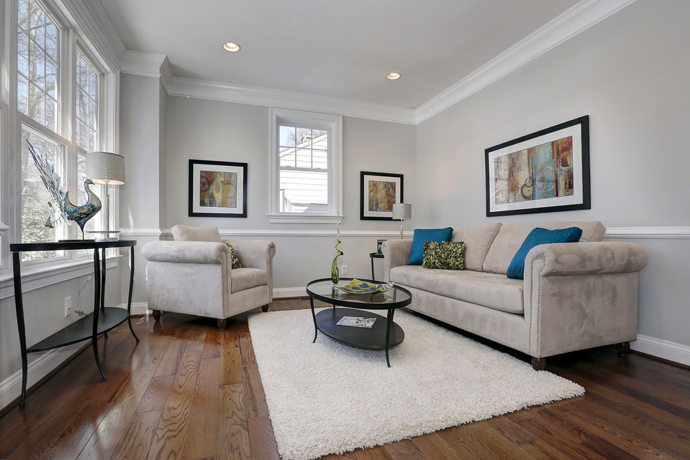 Photo of a mid-sized transitional formal enclosed living room in DC Metro with grey walls and medium hardwood floors.