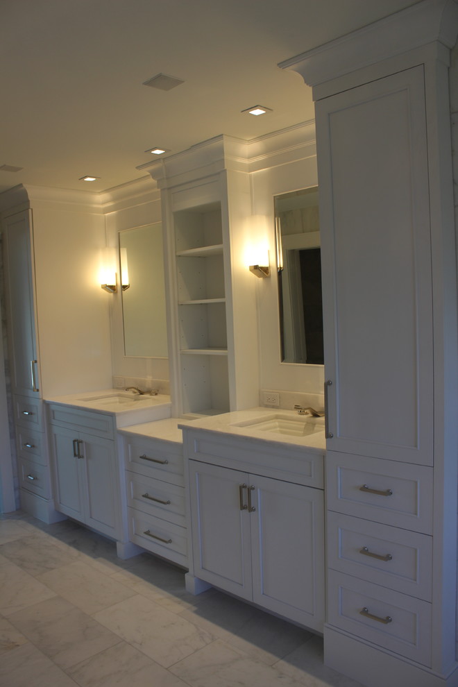 Inspiration for a large transitional master marble floor and white floor doorless shower remodel with shaker cabinets, white cabinets, white walls, an undermount sink, marble countertops and white countertops