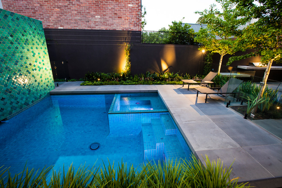Inspiration for a large contemporary custom-shaped pool in Melbourne with natural stone pavers.