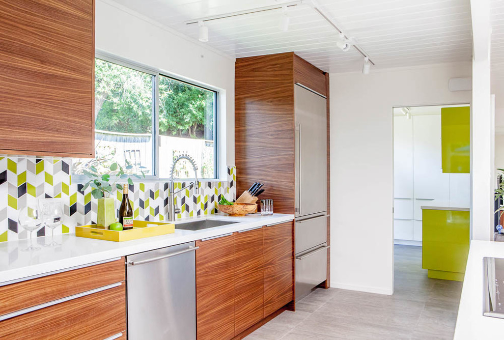 Design ideas for a mid-sized midcentury galley open plan kitchen in San Francisco with an undermount sink, flat-panel cabinets, medium wood cabinets, quartz benchtops, multi-coloured splashback, ceramic splashback, stainless steel appliances, ceramic floors, with island and grey floor.
