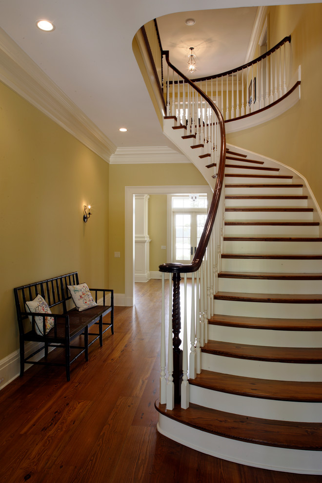 Photo of a mid-sized contemporary wood curved staircase in Atlanta with painted wood risers.