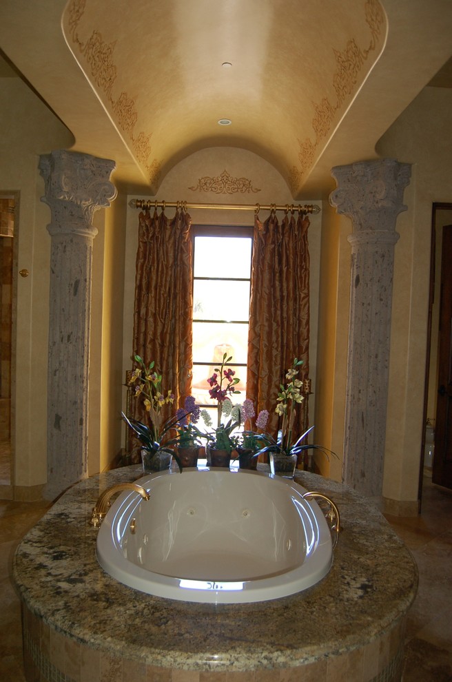 Mid-sized transitional master beige tile and stone tile ceramic tile doorless shower photo in Phoenix with raised-panel cabinets, dark wood cabinets, a hot tub, a one-piece toilet, beige walls and a drop-in sink