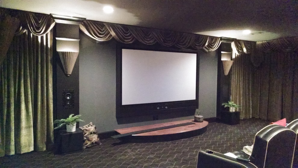 This is an example of a large traditional enclosed home theatre in Atlanta with green walls, carpet, a built-in media wall and grey floor.