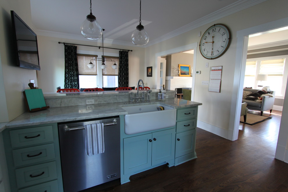 Kitchen - transitional medium tone wood floor kitchen idea in Omaha with a farmhouse sink, shaker cabinets, white cabinets, quartzite countertops, white backsplash, ceramic backsplash, stainless steel appliances and a peninsula