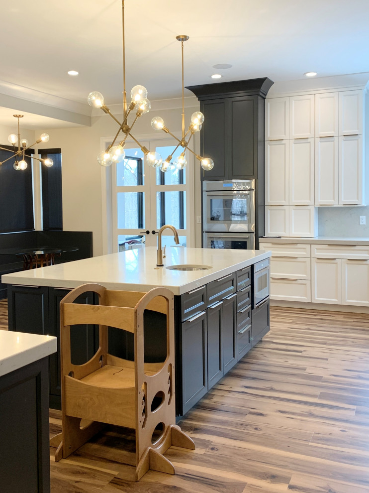 Design ideas for an expansive modern u-shaped open plan kitchen in Other with flat-panel cabinets, engineered stone countertops, engineered quartz splashback, stainless steel appliances and multiple islands.