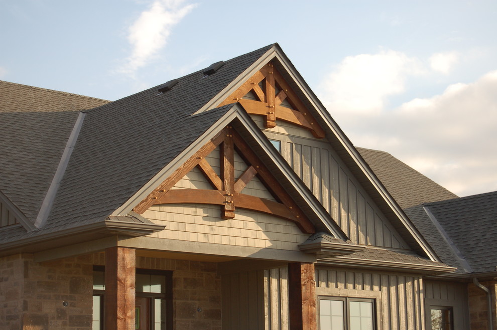 This is an example of a mid-sized country two-storey brown exterior in Toronto with mixed siding and a gable roof.