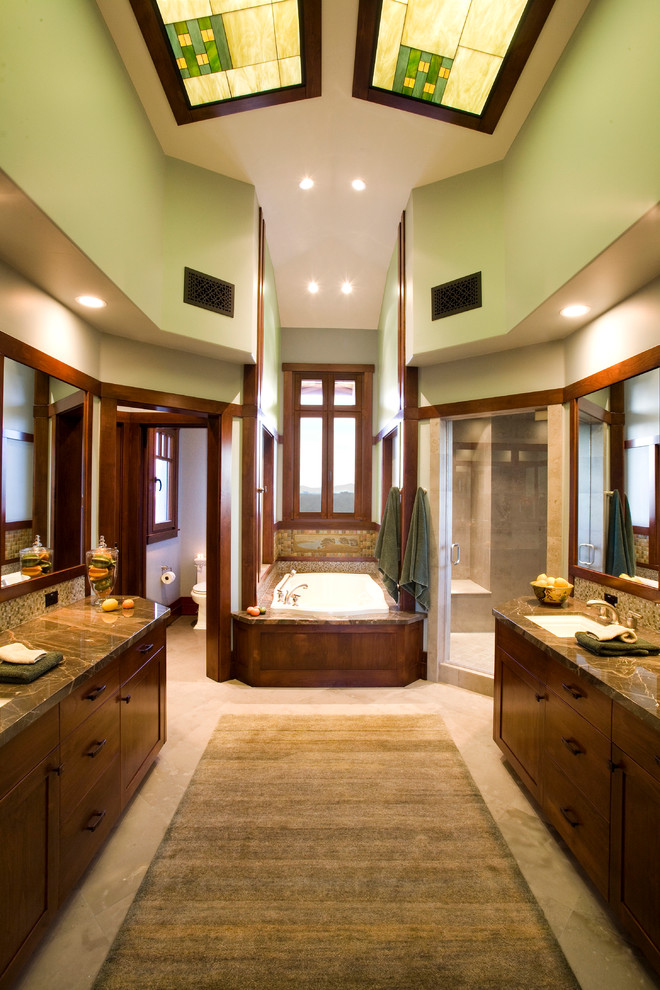 Expansive arts and crafts master bathroom in San Diego with shaker cabinets, medium wood cabinets, a drop-in tub, a corner shower, a one-piece toilet, beige tile, marble, green walls, marble floors, an undermount sink and marble benchtops.
