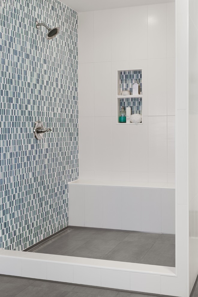 This is an example of a traditional bathroom in Other with an alcove shower, glass sheet wall, blue walls, ceramic floors and multi-coloured tile.