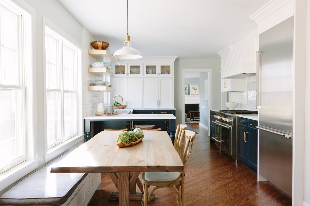 Kitchen - transitional kitchen idea in Chicago with a farmhouse sink, shaker cabinets, blue cabinets, white backsplash, marble backsplash and stainless steel appliances