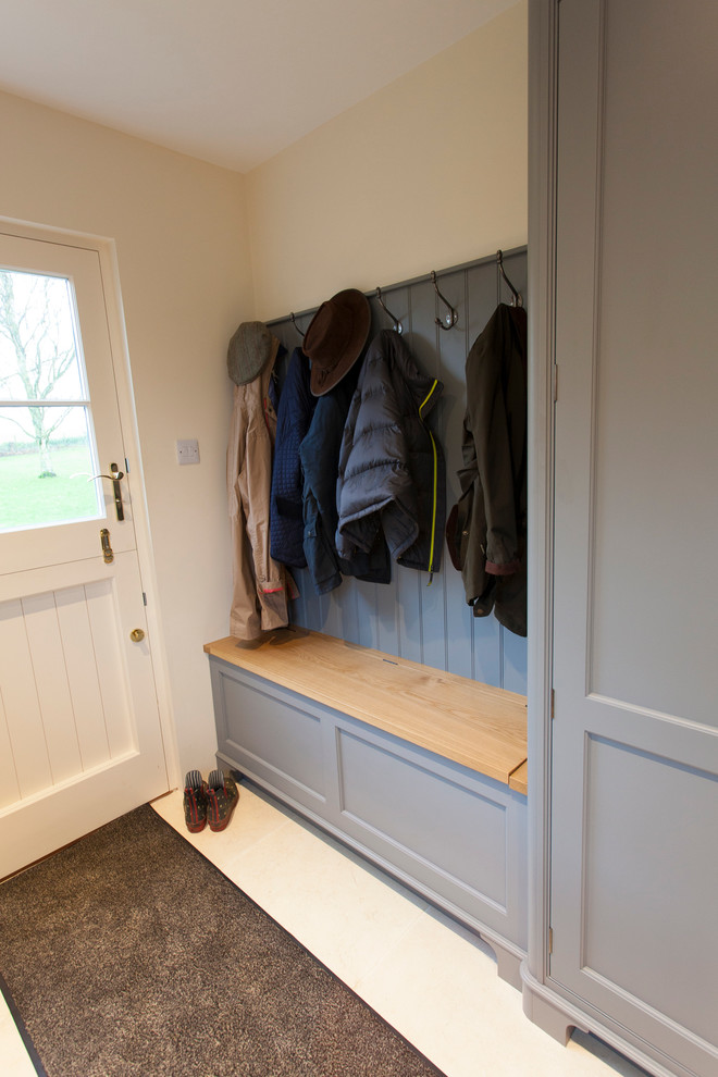 This is an example of a mid-sized traditional entryway in Essex with limestone floors.