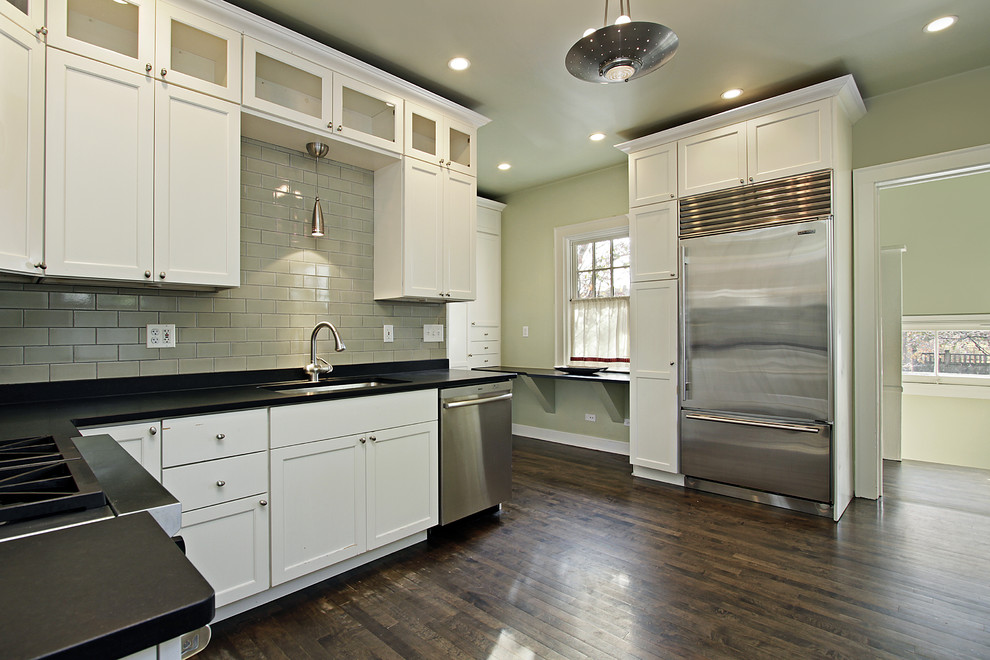 Inspiration for a large dark wood floor eat-in kitchen remodel in Minneapolis with an undermount sink, white cabinets, green backsplash and stainless steel appliances