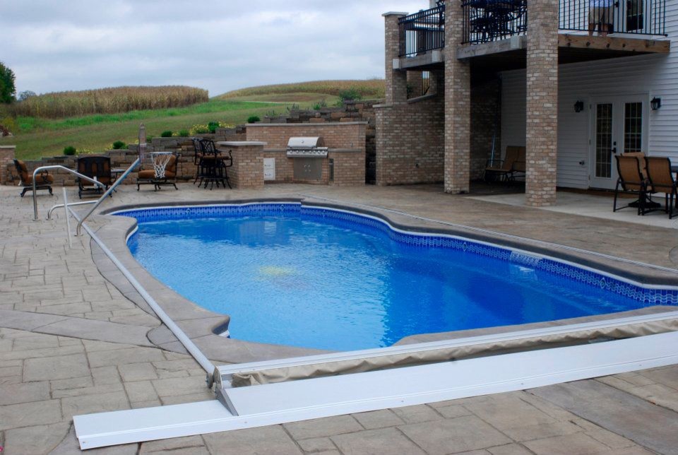 Mid-sized backyard custom-shaped pool photo in Indianapolis