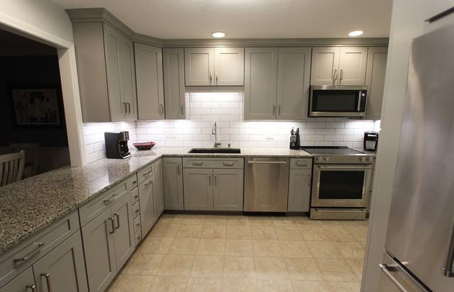 Grey Kitchen With White Subway Tile Backsplash And Granite