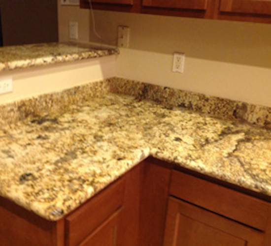 Example of a mid-sized l-shaped enclosed kitchen design in Phoenix with no island