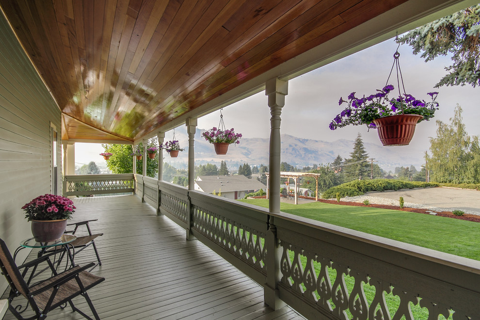 Inspiration for a traditional balcony in Seattle with a roof extension.