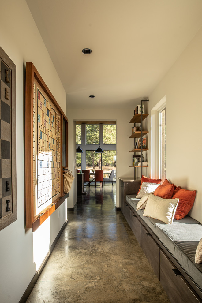Mid-sized modern hallway in Seattle with brown walls, concrete floors and grey floor.