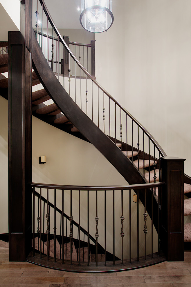 Design ideas for a traditional carpeted curved staircase in Calgary.