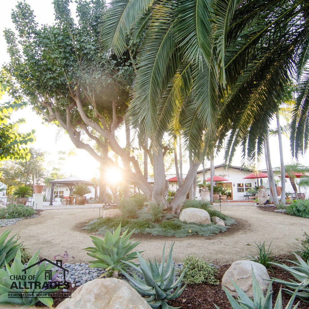 Inspiration for an expansive eclectic side yard patio in San Diego with gravel and no cover.