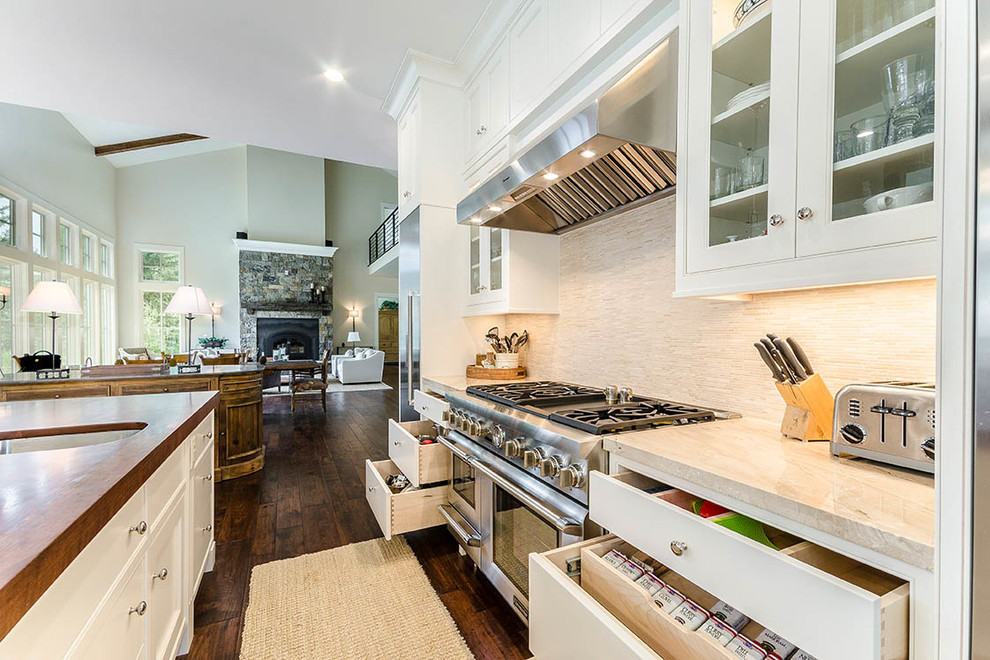 Example of a huge transitional l-shaped dark wood floor and brown floor eat-in kitchen design with an undermount sink, shaker cabinets, white cabinets, wood countertops, gray backsplash, matchstick tile backsplash, stainless steel appliances and an island