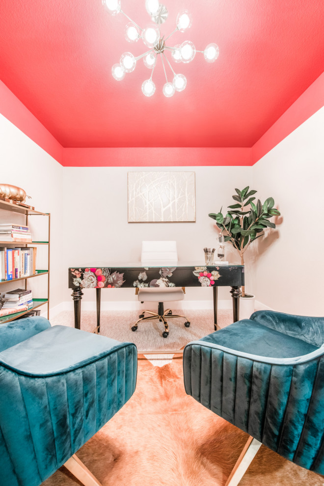 This is an example of a mid-sized midcentury study room in Denver with pink walls, carpet, no fireplace, a freestanding desk and grey floor.