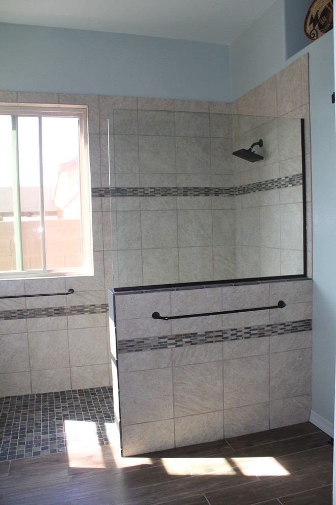 Example of a mid-sized transitional master beige tile and porcelain tile porcelain tile and brown floor walk-in shower design in Phoenix with flat-panel cabinets, black cabinets, a two-piece toilet, blue walls, an undermount sink and quartz countertops