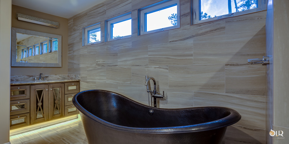 Freestanding bathtub - transitional master dark wood floor and beige floor freestanding bathtub idea with flat-panel cabinets, light wood cabinets and gray walls