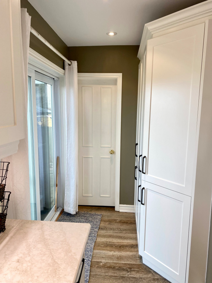 Inspiration for a mid-sized transitional l-shaped enclosed kitchen remodel with a double-bowl sink, recessed-panel cabinets, white cabinets, gray backsplash, glass tile backsplash and no island