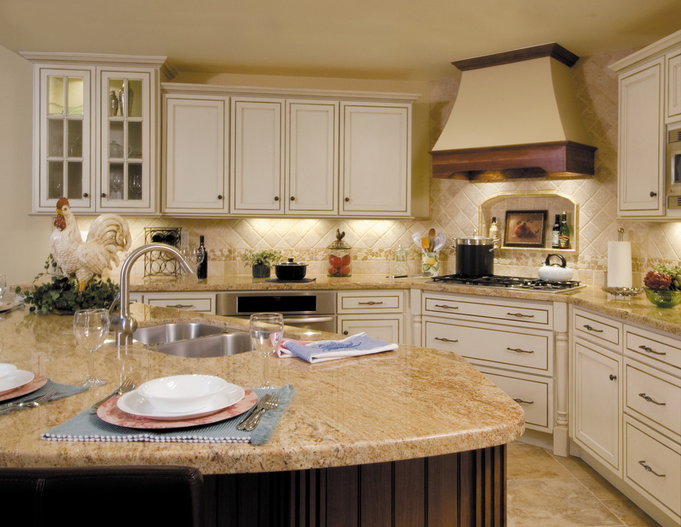Large traditional l-shaped eat-in kitchen in Other with recessed-panel cabinets, white cabinets, stainless steel appliances, with island, an undermount sink and beige splashback.