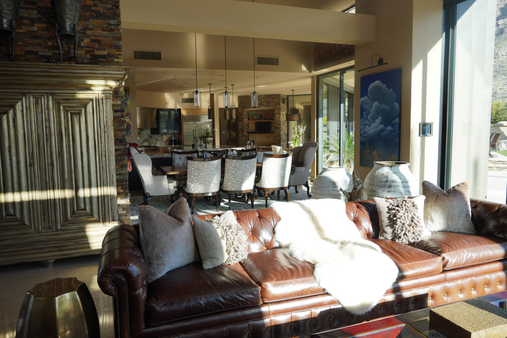 This is an example of an expansive contemporary formal open plan living room in Phoenix with beige walls, limestone flooring, a corner fireplace, a stacked stone fireplace surround, a wall mounted tv, beige floors and a wood ceiling.