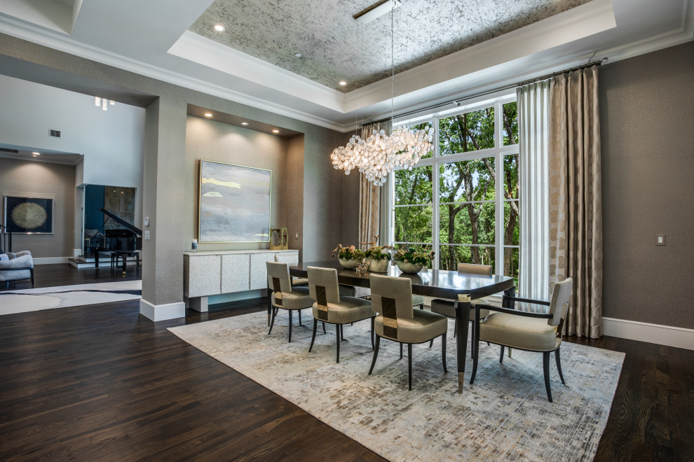 Large transitional separate dining room in Dallas with metallic walls, medium hardwood floors, a ribbon fireplace, a tile fireplace surround, brown floor, recessed and wallpaper.