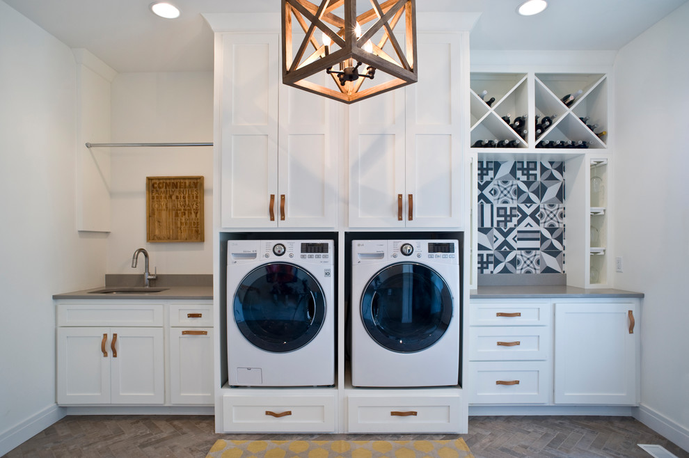 Small modern single-wall utility room in Other with an undermount sink, raised-panel cabinets, white cabinets, quartz benchtops, white walls, brick floors, a side-by-side washer and dryer and multi-coloured floor.