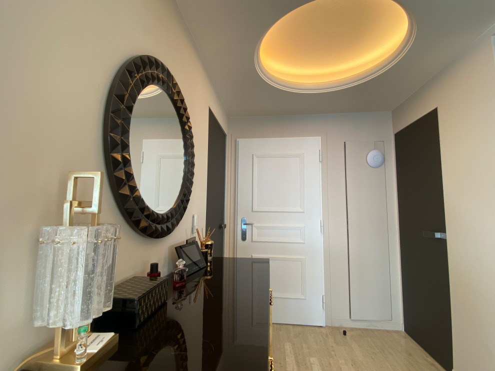 Photo of a medium sized contemporary front door in Nice with beige walls, travertine flooring, a white front door, beige floors, a drop ceiling and feature lighting.