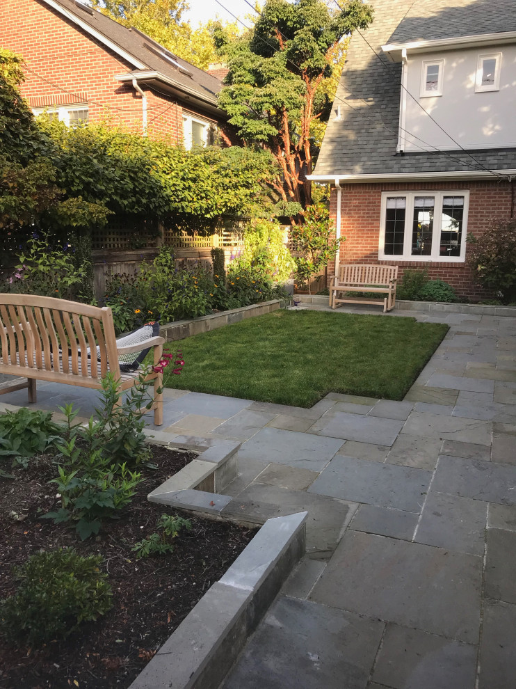 This is an example of a small traditional backyard partial sun formal garden for summer in Seattle with with fireplace and natural stone pavers.