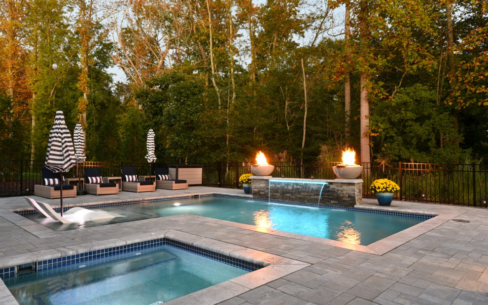 Design ideas for a mid-sized contemporary backyard l-shaped pool in Other with a water feature and concrete pavers.