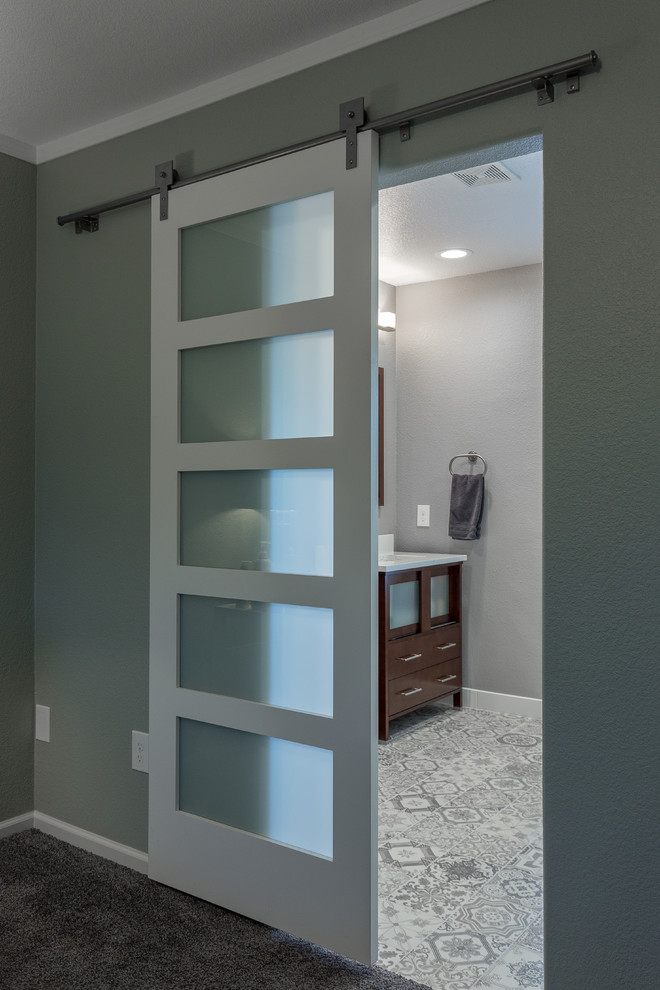 Photo of a mid-sized contemporary master bathroom in Denver with furniture-like cabinets, medium wood cabinets, a corner shower, a two-piece toilet, gray tile, ceramic tile, grey walls, ceramic floors, an undermount sink and engineered quartz benchtops.
