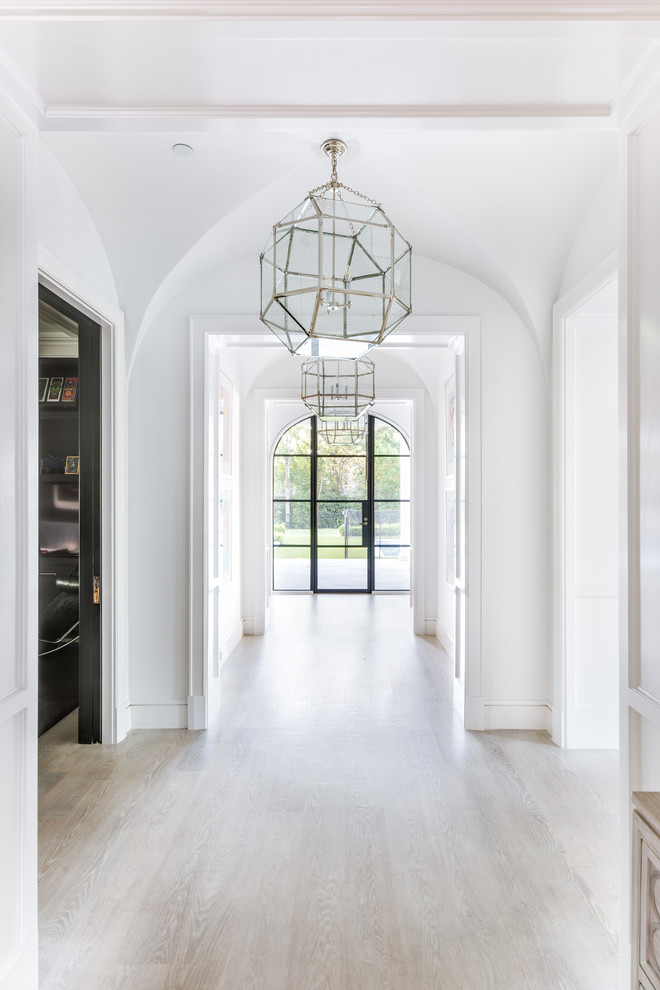 Design ideas for a transitional hallway in Dallas with white walls and beige floor.