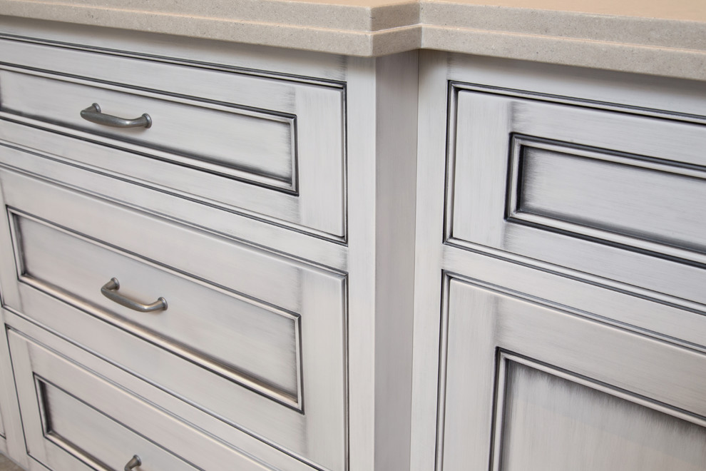 Example of a large transitional l-shaped ceramic tile open concept kitchen design in Phoenix with an undermount sink, beaded inset cabinets, gray cabinets, quartz countertops, white backsplash, glass tile backsplash, black appliances and an island