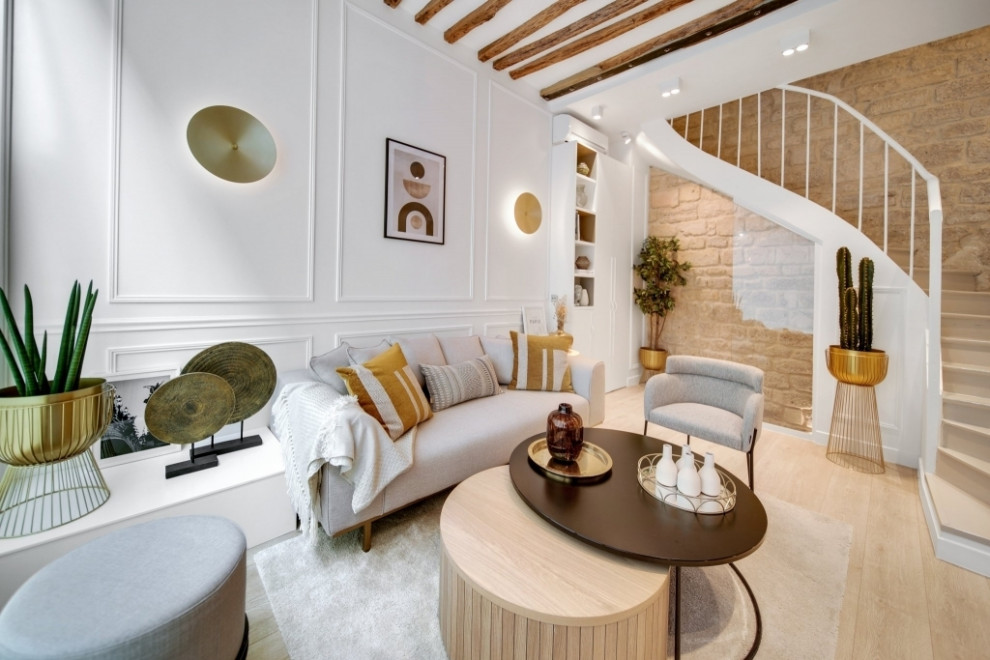 Design ideas for a small transitional enclosed living room in Paris with a library, white walls, light hardwood floors, no fireplace, a wall-mounted tv, brown floor and exposed beam.